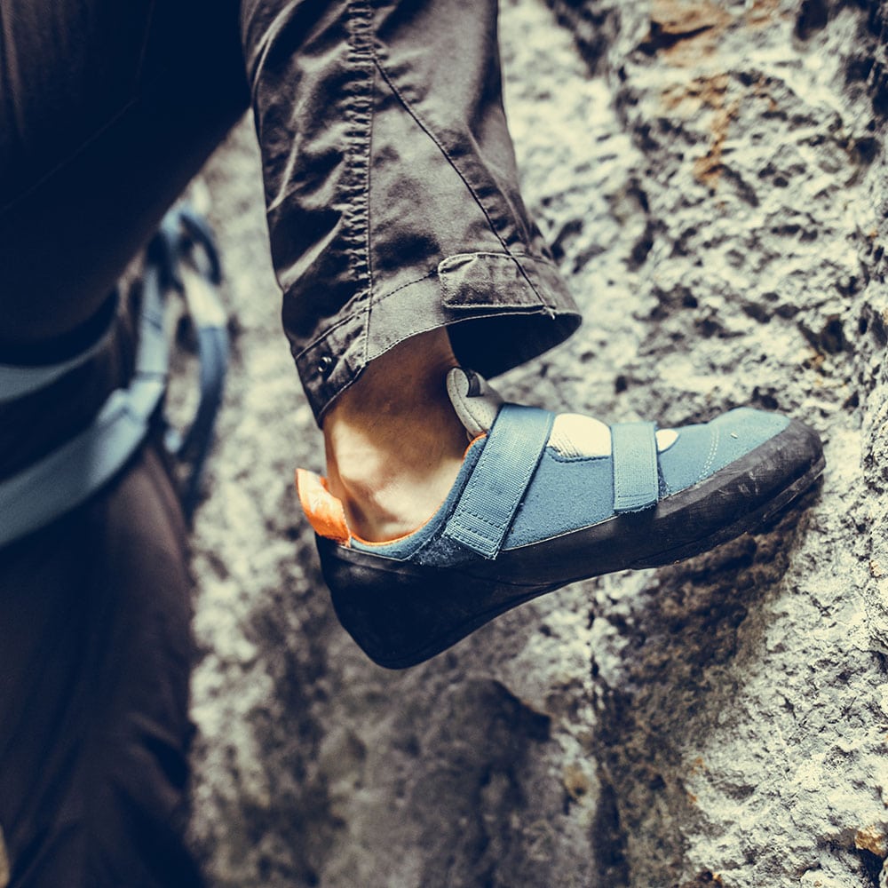 person wearing rock climbing shoes