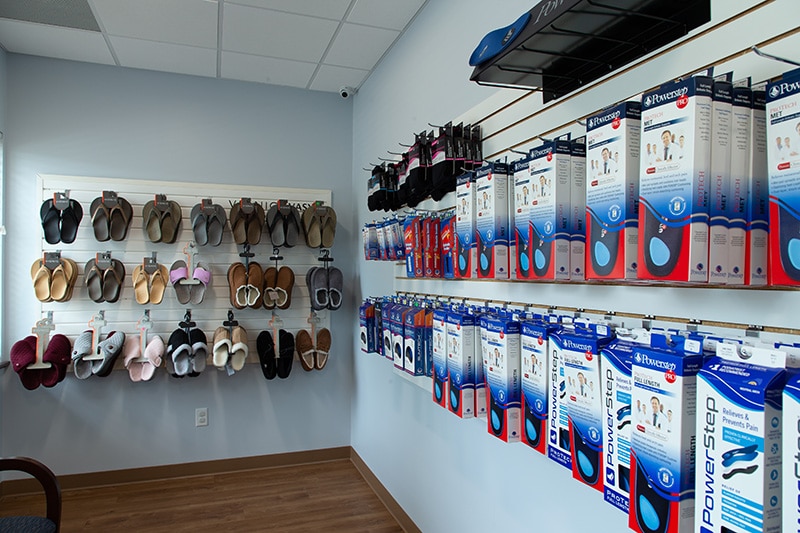 Walls covered in slippers, sandals and orthotics available to purchase