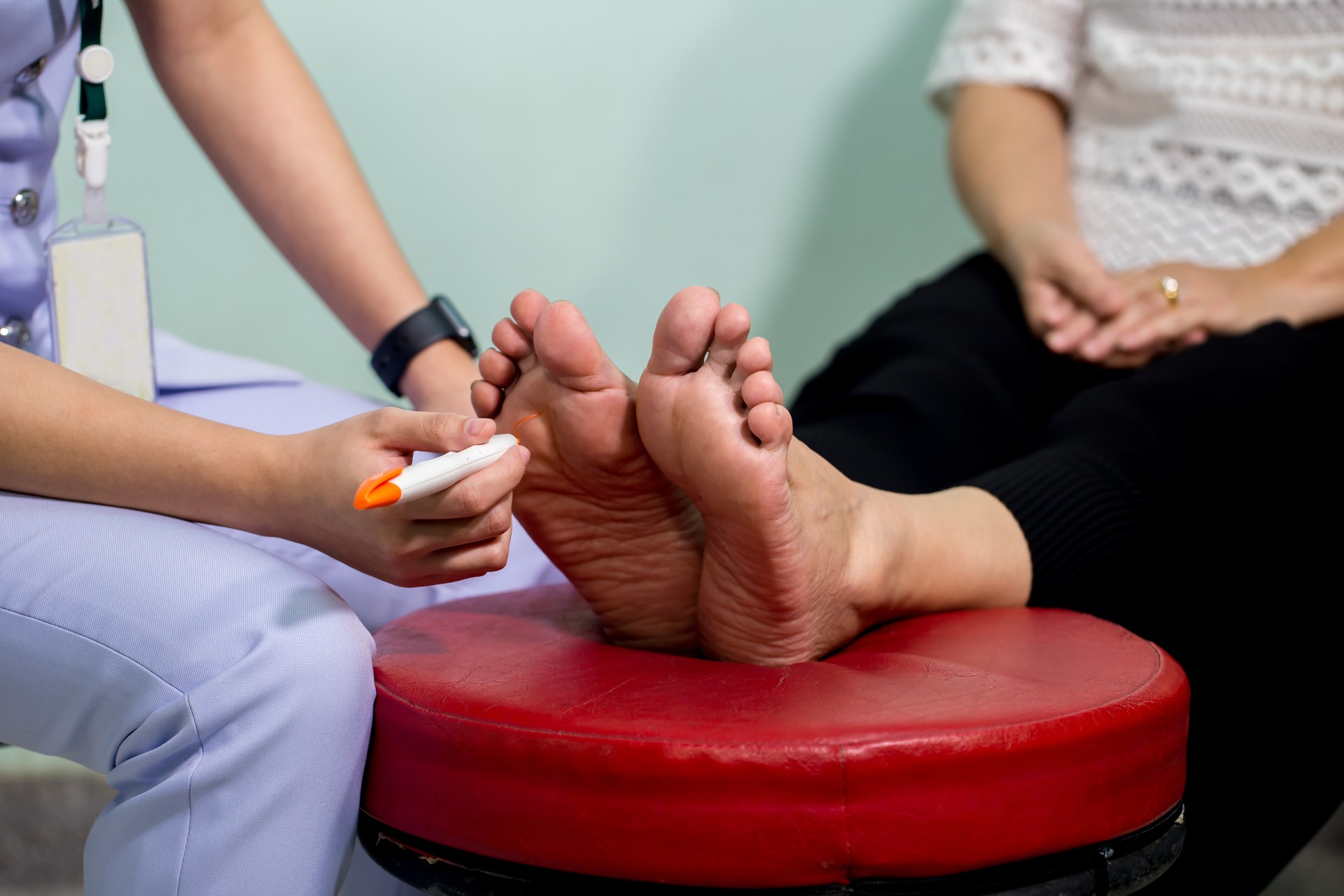 a doctor checking a diabetic patient's feet