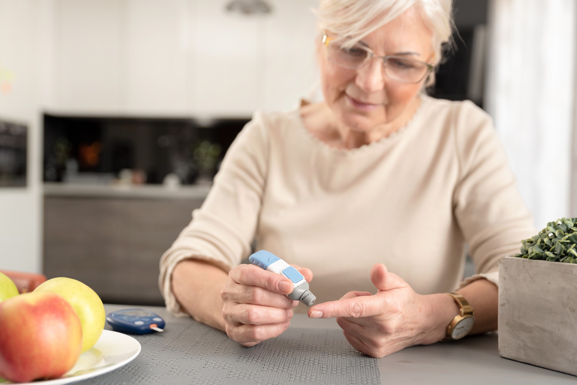 elderly woman checking her blood sugar levels