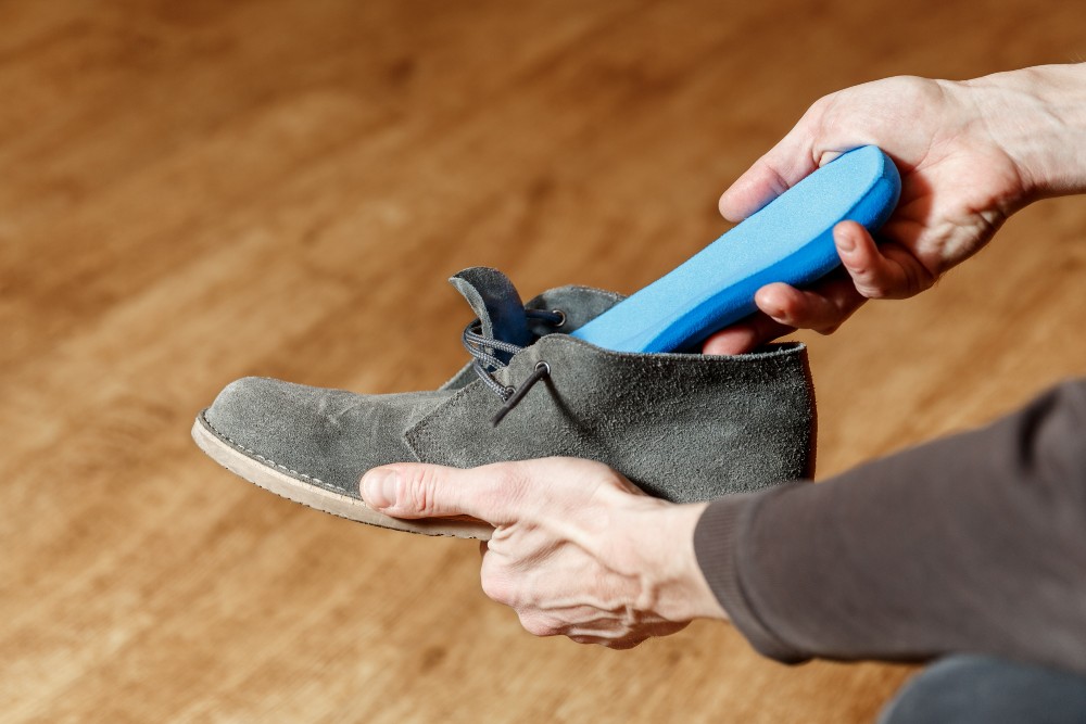 Person putting custom orthotics into their shoes