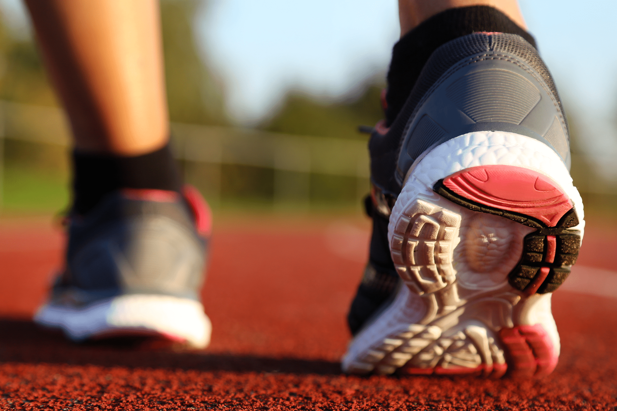 Woman running on athletic track<br />
